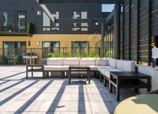 Outdoor lounge area with large sectional and 3 side tables at Aspire at CityPlace