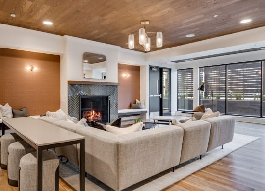 Community room with lit fireplace and comfortable couch seating at Aspire at CityPlace