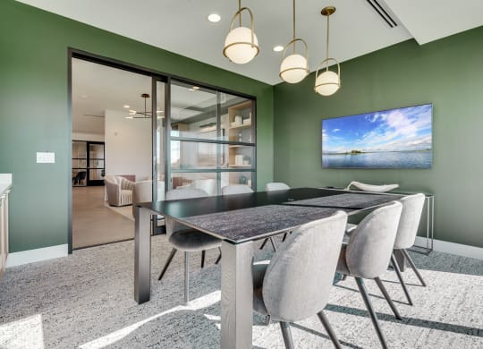 Conference room with long table and glass sliding door at luxury apartment in Woodbury