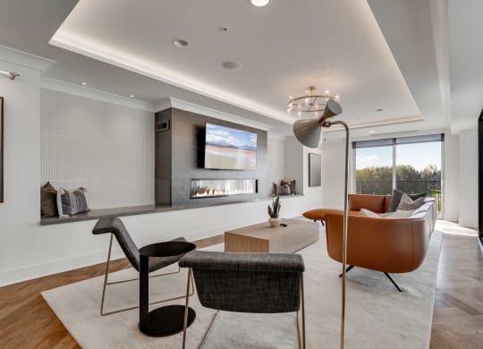 Community lounge space with electric fireplace and balcony at Aspire at CityPlace