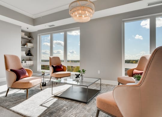 Seating area with large windows and four chairs facing each other in a community space