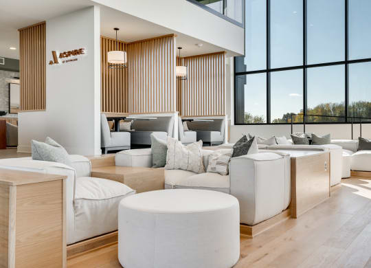 Couch seating and built in booth areas with full-wall windows in the lobby at Aspire at CityPlace