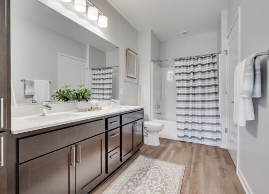 Spacious bathroom with dual vanities and lots of storage in luxury apartment in Woodbury MN 55125