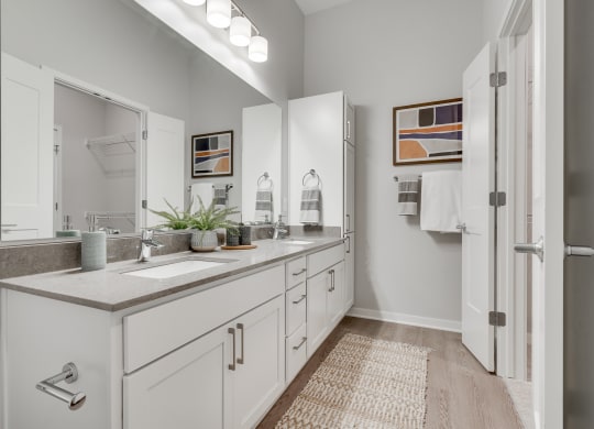 Bathroom with dual vanities and French doors in a luxury two bedroom apartment in Woodbury MN 55125