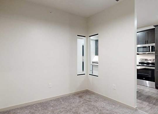 a sleeping area with a privacy wall with a small window