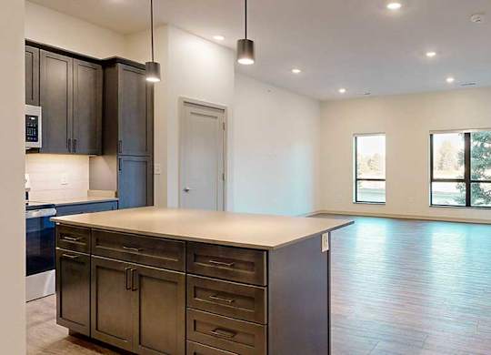 a view of a spacious living room from a kitchen island countertop