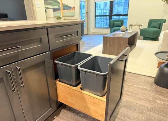 a kitchen with three storage bins in a counter top