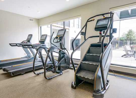 a 24-hour fitness center with treadmills, ellipticals, and a Stairmaster