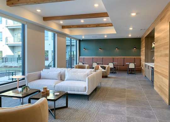 a modern front lounge area with various couch and café-style seating