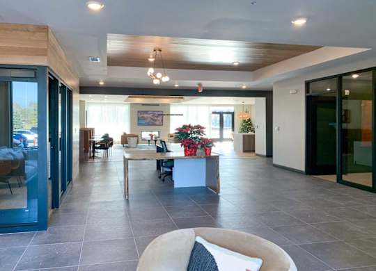 the front lobby area with a large leasing desk between two offices