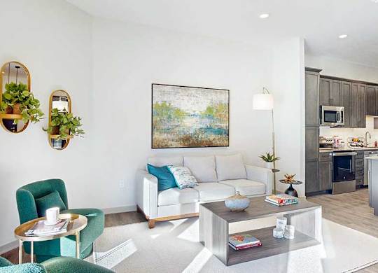 a furnished living room with midcentury modern furniture and plenty of natural light