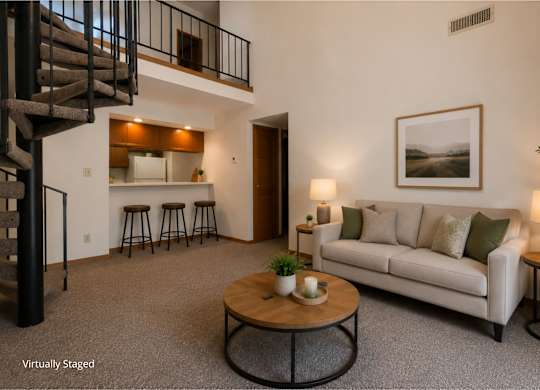 Two-story apartment living room with a loft layout, carpeted flooring, a spiral staircase, open breakfast bar with seating, and a spacious living area with modern furnishings.