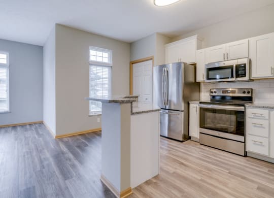 Kitchen with stainless steel appliances and island at Cascade Pines duplex and townhomes