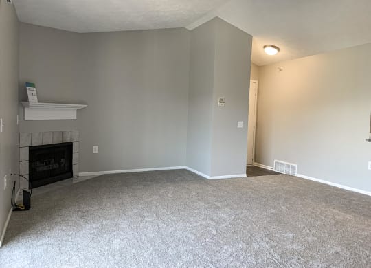 Spacious living room with cozy fireplace at Eagle Run Apartments in Omaha Nebraska