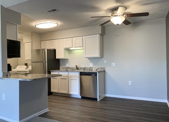 Renovated kitchen with white cabinets and stainless steel appliances at Eagle Run Apartments in Omaha Nebraska