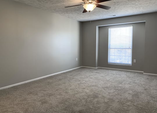 Carpeted bedroom with walk in closet at Eagle Run Apartments in Omaha Nebraska