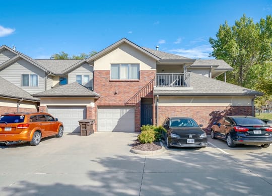 a two-story villa with brick exterior and attached garages