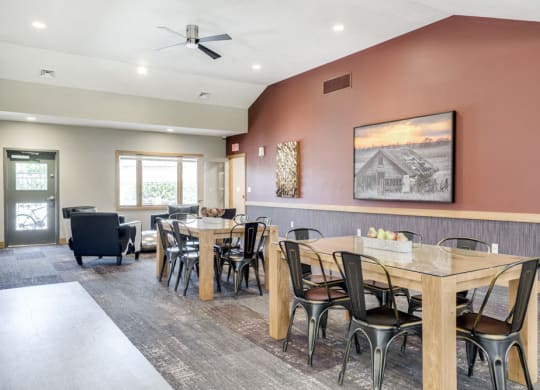 Tables and seating in the clubhouse at Fountain Glen Apartments