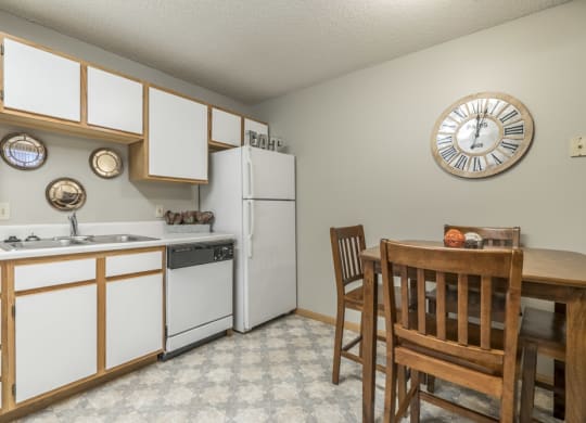 Traditional style kitchen with white cabinets and wooden trim