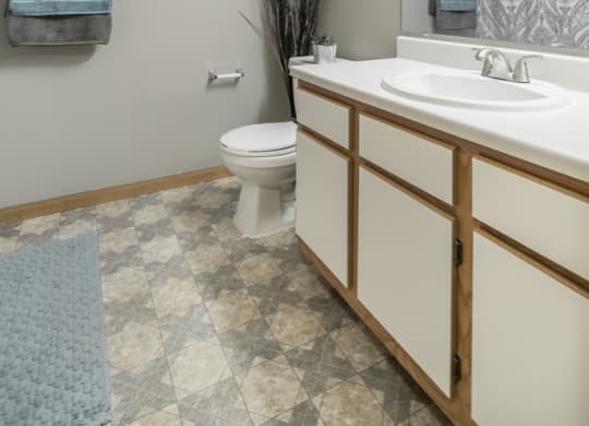 Traditional style bathroom with white cabinets with wooden trim