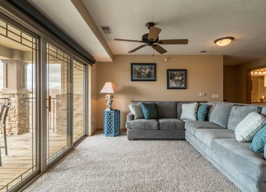 a living room with a couch and a ceiling fan