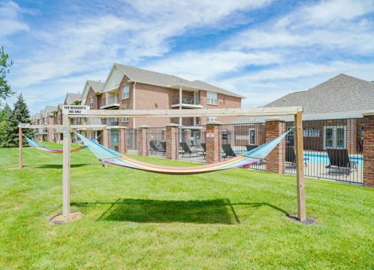 a pair of hammocks near the community clubhouse and pool
