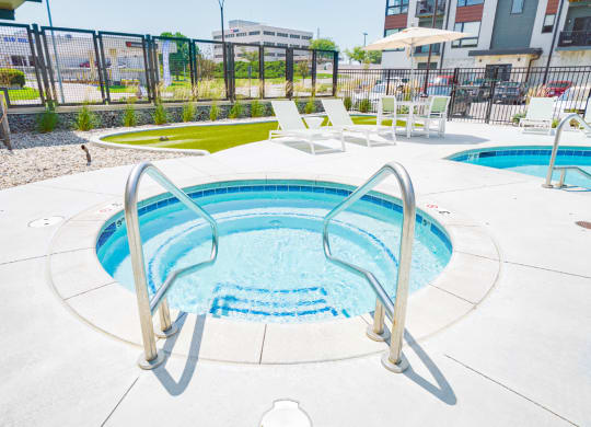 a relaxing in-ground hot tub at the Haven at Uptown apartments