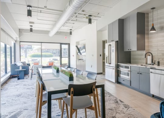 community room with lounge seating and kitchen at Haven at Uptown in Lincoln, NE