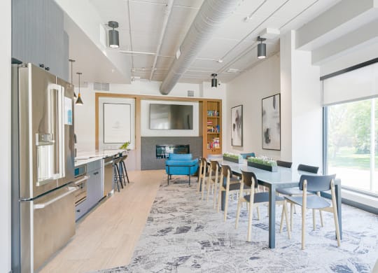 a kitchen and dining room with a blue table and chairs