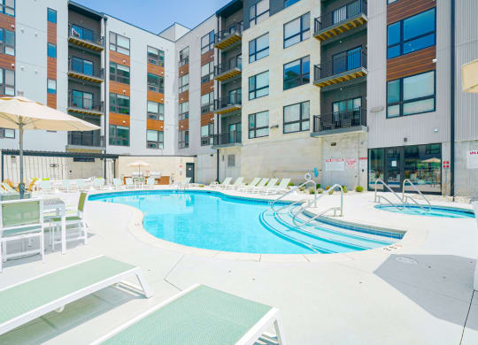 a swimming pool in front of Haven at Uptown apartments
