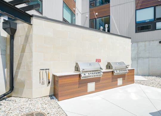 two poolside grills outside of Haven at Uptown apartments