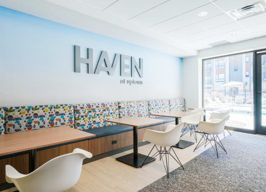 a dining room with tables and chairs and a hansen logo