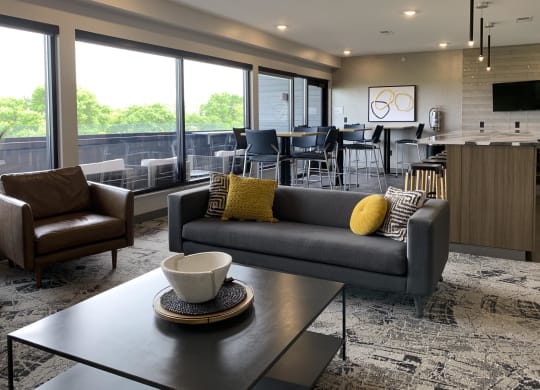 the sky lounge filled with furniture and a large window out looking the deck