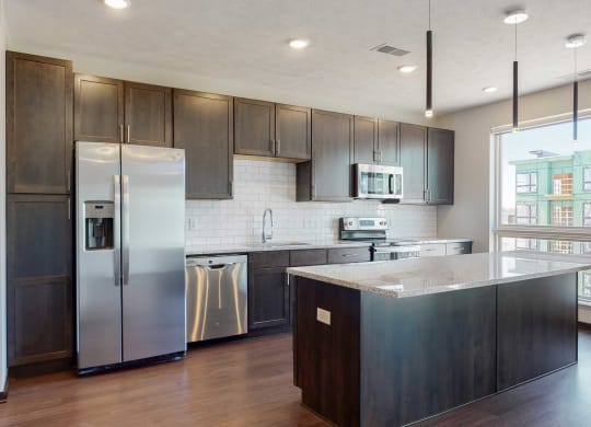 Beautiful kitchen island which provides plenty of extra storage with the additional cabinet space provided at Haven at Uptown in Lincoln, NE