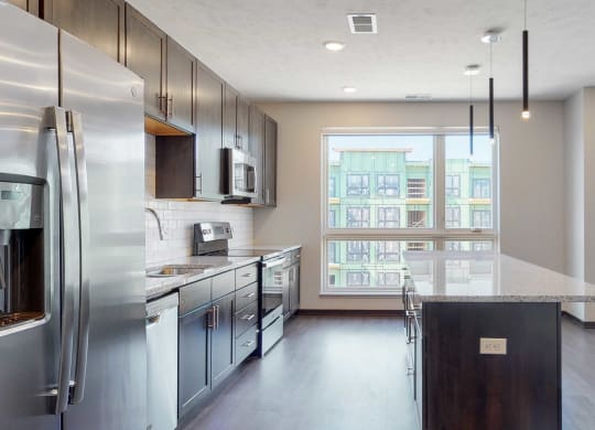 Spacious kitchen with mocha finishes in the Melody floor plan at Haven at Uptown in Lincoln, NE