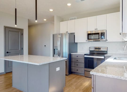 Two tone slate finishes in the Shine floor plan kitchen at Haven at Uptown in Lincoln, NE