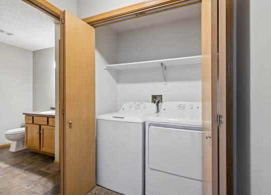 A small laundry room with a washer and dryer.