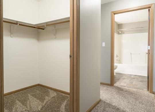 a walk-in closet in the second bedroom and a door open to the attached bathroom