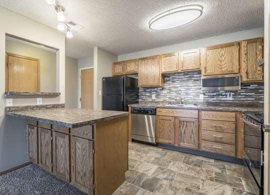 a renovated kitchen with tile backsplash and new appliances