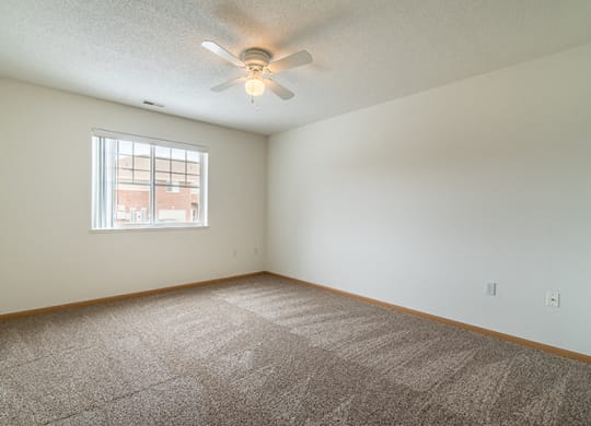 Bedroom with ample natural lighting and ceiling fan at Northbrook Apartments