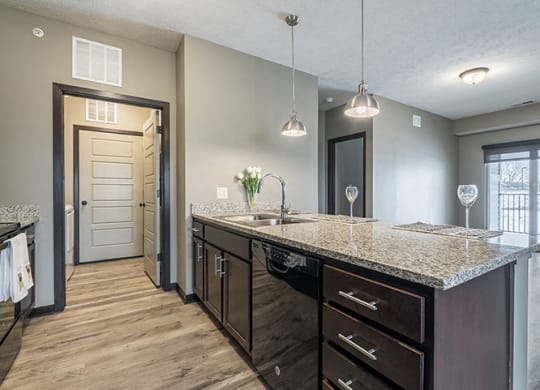 Kitchen with granite counters and island at North Pointe Villas
