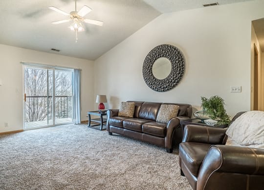 Large roomy living room with balcony at The Northbrook Apartment Homes, Lincoln, NE