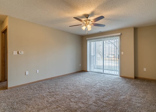 Living room with sliding glass doors at Skyline View Apartments in Lincoln NE