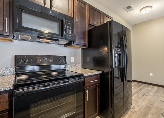 Kitchen with GE appliances and microwave at North Pointe Villas