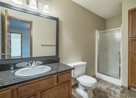 Full bathroom with shower and plenty of storage space at Fountain Glen Apartments