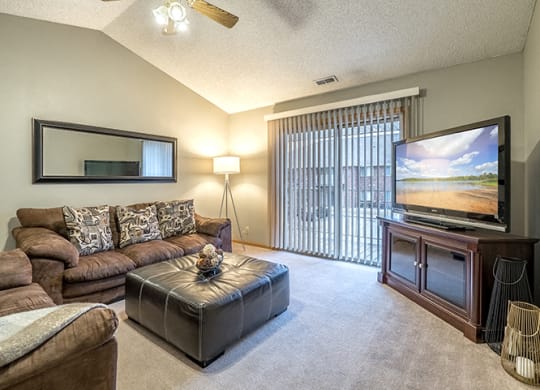 Living room with large sliding doors at Fountain Glen Apartments