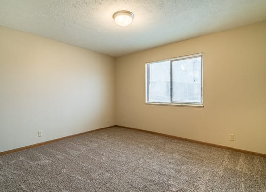 Large bedroom with natural light at Fountain Glen Apartments