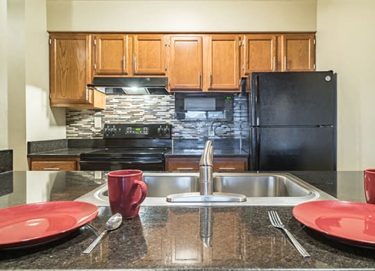 View of kitchen from the seating at a breakfast bar at Fountain Glen Apartments