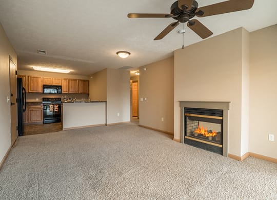 a living room with a two-way fireplace, and a kitchen with a bartop