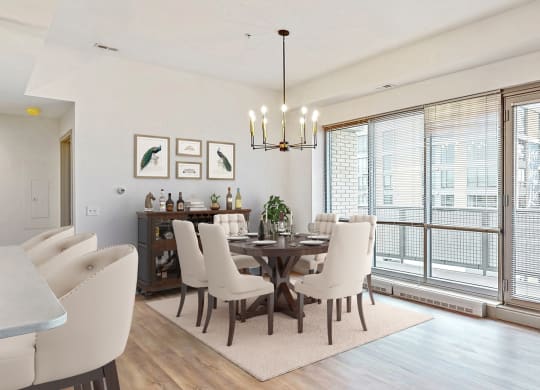 Enjoy the scenic views from the floor-to-ceiling windows in the dining and living area of a 2 bedroom penthouse floor plan at Midtown Crossing Apartments Omaha